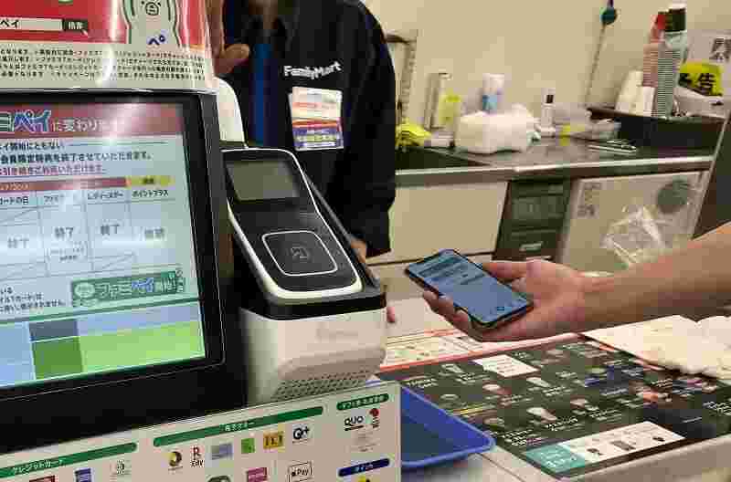 ファミリーマートのレジにスマホを差し出している。