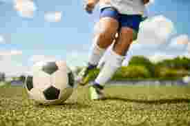 サッカーをしている少年の足とボール