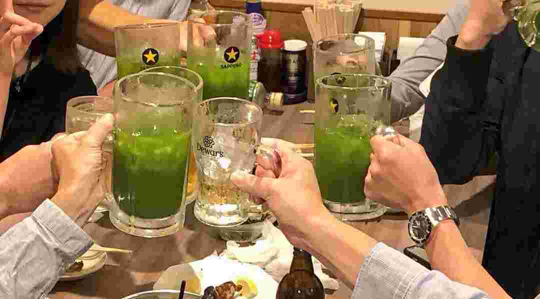 ジョッキに入ったサワーで乾杯しているテーブル