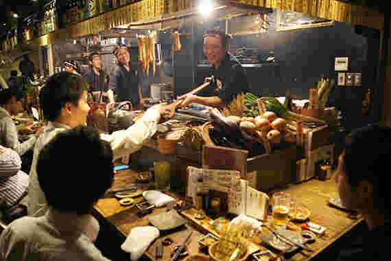 炉端焼きで店主と客のやり取り風景