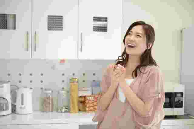 キッチンで喜ぶ女性