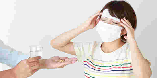 きつそうな女性と薬を差し出している人の手