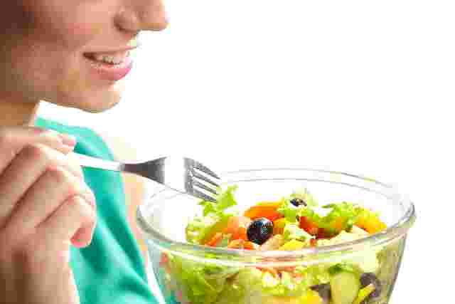 サラダを食べようとする女性の手元