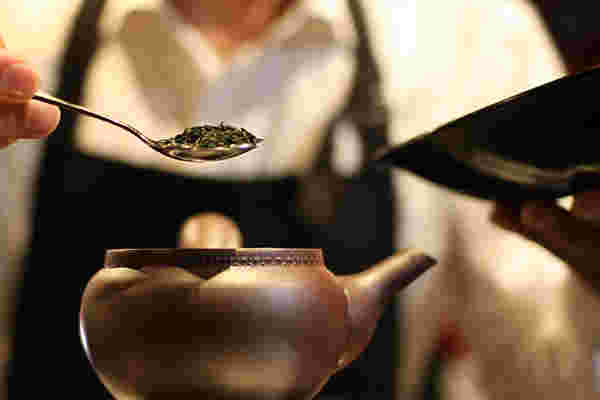 芽茶の茶葉をティースプーンで急須に入れる様子