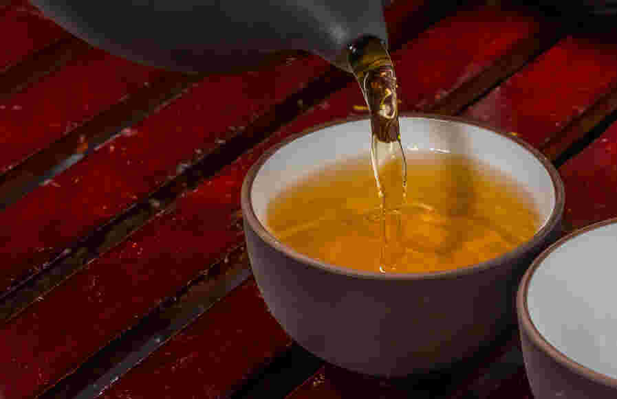 デトックス効果のあるバナバ茶を湯飲みに注いでいるところ