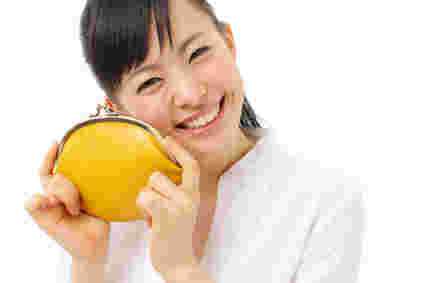 がま口財布を手にし、笑う女性