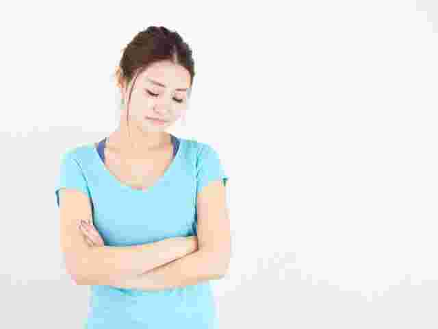 下を向いて悩む様子の女性