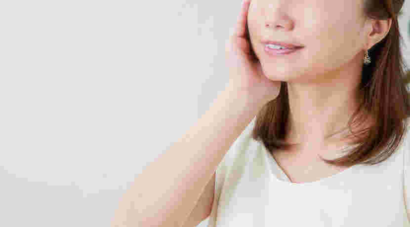 頬をさわる女性