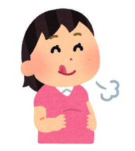 満足そうにお腹を抱える女性