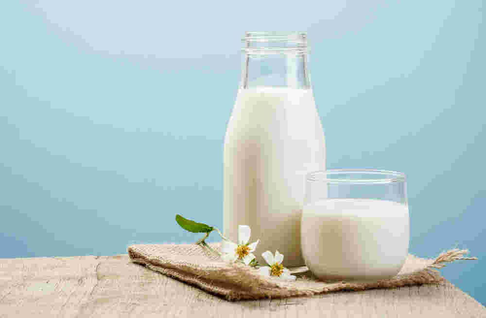ガラス瓶に入った牛乳とガラスのカップに入った1杯の牛乳
