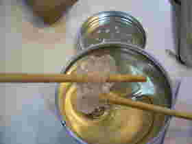 2本の棒を使って水飴をねっている様子