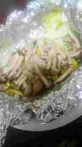 ホイルで包まれて蒸された香ばしいキノコとキャベツ