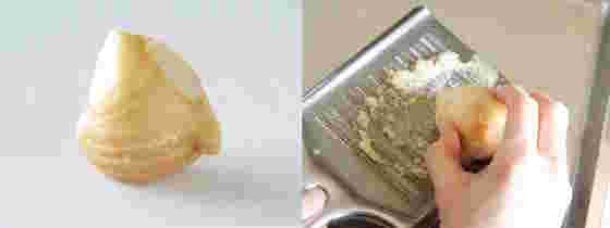 一欠片の生姜とおろし金ですりおろし中の生姜