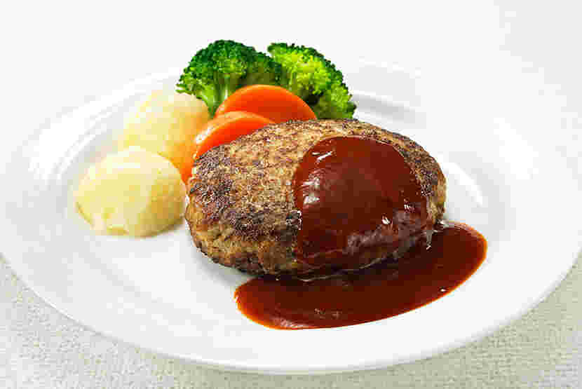 デミグラスソースがかかったハンバーグと付け合わせの野菜