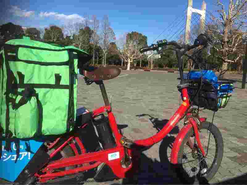 配達するバックを後ろに乗せた赤い自転車
