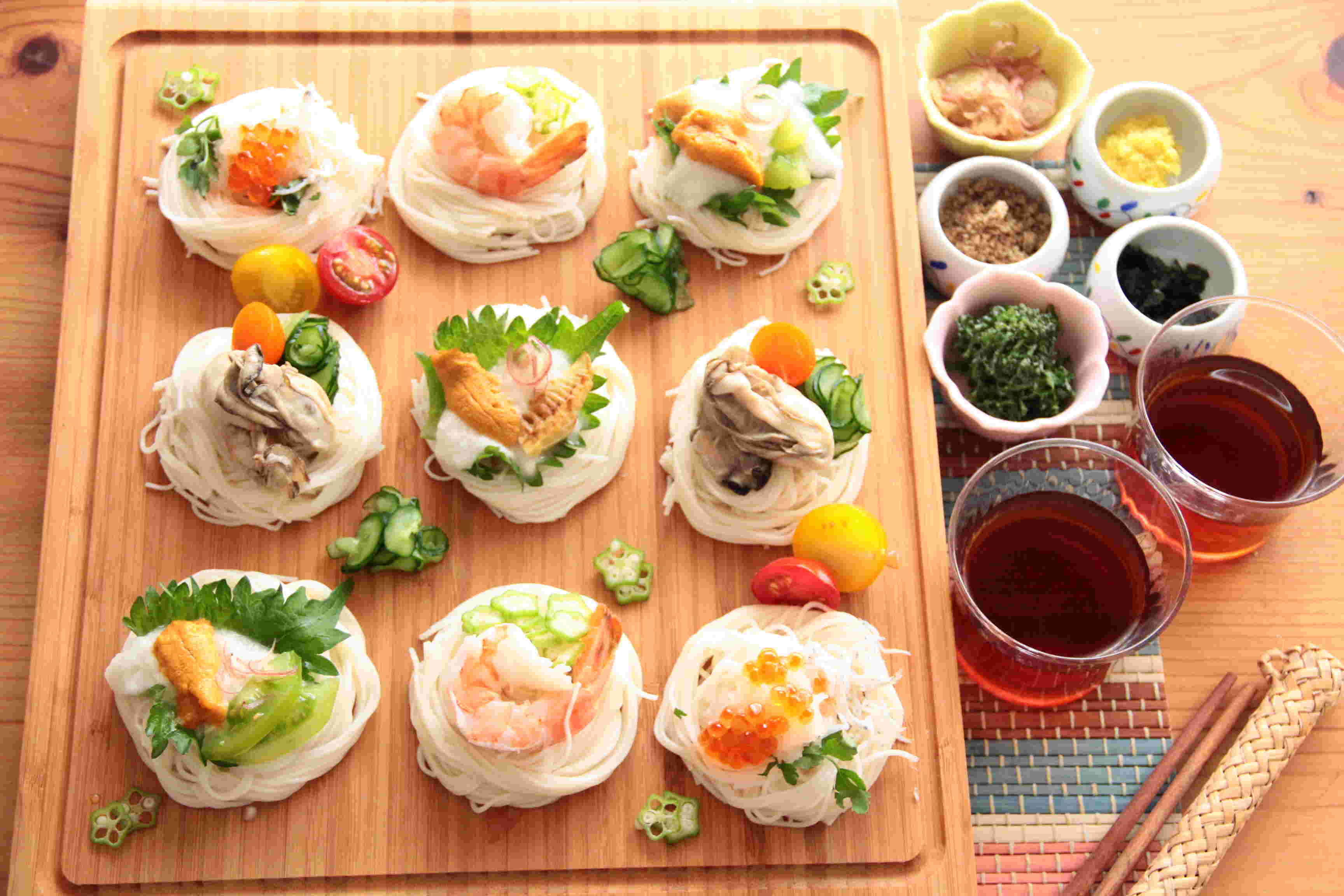そうめんに魚介類のトッピングをしている