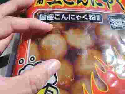 ピリ辛玉こんにゃくの大きさを指で測っている画像
