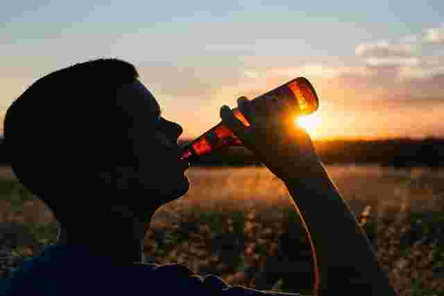 お酒をラッパ飲みする男性