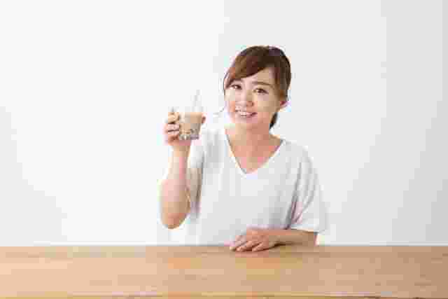 タピオカミルクティを持っている女性