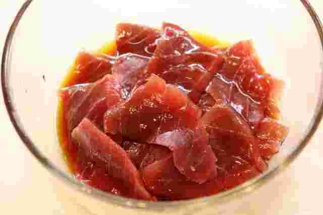 マグロ漬け用にタレに漬け込んでいるマグロ
